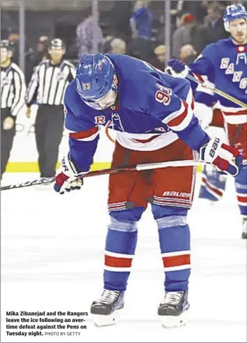  ?? PHOTO BY GETTY ?? Mika Zibanejad and the Rangers leave the ice following an overtime defeat against the Pens on Tuesday night.