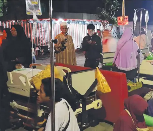  ?? Picture: AFP ?? ORDEAL: Hospital patients and relatives wait outside after being evacuated when an earthquake rocked Indonesia's Lombok island, in Mataram.