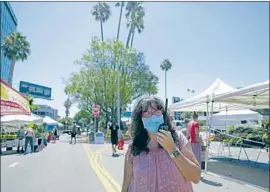  ?? Myung J. Chun Los Angeles Times ?? ESTHER WALKER, Studio City Farmers Market director, said vendors should be able to sell prepared food for takeout, as restaurant­s and food trucks can.