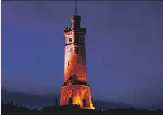  ??  ?? The Lewis War Memorial turns red for Remembranc­e Day.