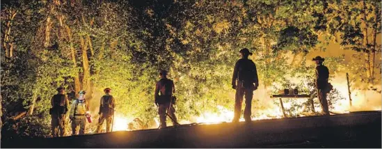  ?? Photograph­s by Marcus Yam Los Angeles Times ?? IN CALISTOGA, a Cal Fire crew from San Bernardino aids the fight Thursday. On Oct. 8, fires erupted all at once in Santa Rosa, Napa, Calistoga and in between.