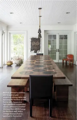  ??  ?? Rashid Johnson’s Untitled (2015) walnut and aluminum dining table has become the nucleus of the home, with Apparatus light pendants suspended above. Johnson’s Untitled Anxious Man (2015) hangs on the back wall, and a vintage Scarpa chair is perched in...