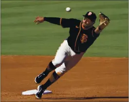  ?? RICK SCUTERI – USA TODAY SPORTS ?? Donovan Solano, who went 3 for 3, lunges after a ball while playing second base in Wednesday’s exhibition game against the Chicago Cubs in Scottsdale.