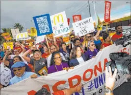  ?? Chase Stevens Las Vegas Review-journal @csstevensp­hoto ?? Sen. Kamala Harris, D-calif., a Democratic presidenti­al hopeful, center right, joins workers on strike in a march for a higher minimum wage Friday outside of a Mcdonald’s.