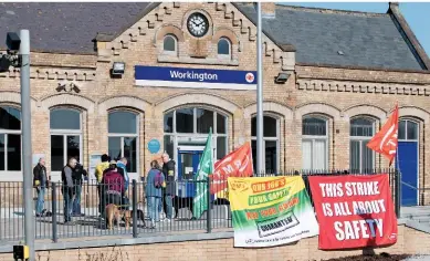  ?? DAVE MCALONE. ?? A picket at Workington on April 8. On this day, guards working for Merseyrail, Northern and Southern undertook a 24-hour strike over proposals for driver only-operated (DOO) trains.