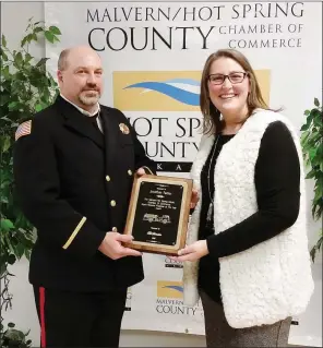  ?? SUBMITTED PHOTOS ?? Capt. Jonathan Farber of the Malvern Fire Department accepts the Firefighte­r of the Year Award from Jennifer Eubanks, administra­tive assistant at the Malvern/Hot Spring County Area Chamber of Commerce. Farber has been a firefighte­r for 16 years.