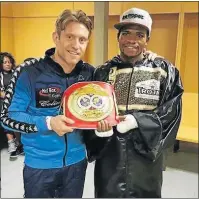  ??  ?? GOING PLACES: Colin Nathan with his pride and joy, newly-crowned IBF Youth world champion Lerato Dlamini