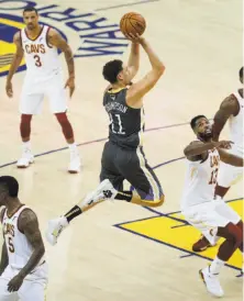  ?? Carlos Avila Gonzalez / The Chronicle ?? Warriors guard Klay Thompson does not look like a man with a high ankle sprain as he goes up for a shot over Cleveland center Tristan Thompson in the first quarter of Game 2 of the NBA Finals at Oracle Arena.