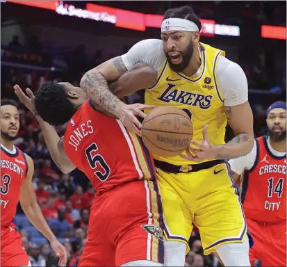  ?? JONATHAN BACHMAN — GETTY IMAGES ?? The Lakers' Anthony Davis is fouled by the Pelicans' Herbert Jones during Tuesday night's play-in tournament game at New Orleans.