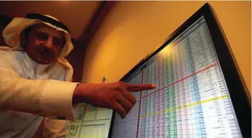  ?? — Reuters ?? An investor gestures as he monitors a screen displaying stock informatio­n in Riyadh, Saudi Arabia.
