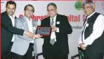  ??  ?? Prakash Kumar, CEO, GST Network receiving the award for his pioneering work in creating a robust tech backbone for GST delivery. Presenting the award is Pradeep Gupta, CMD, CyberMedia