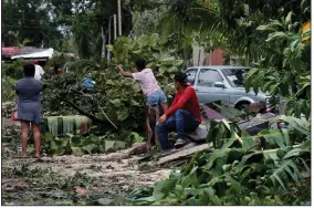  ?? (AP/Marco Ugarte) ?? Locals remove debris from their homes Thursday after the passage of Hurricane Grace in Tulum, Quintana Roo state, Mexico. More photos at arkansason­line.com/820grace/.