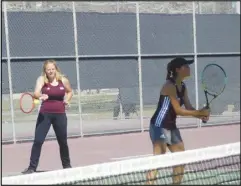  ?? MERISA JENSEN/Valley Press ?? AVC’s Brooke Faulk (left) returns a shot to Ventura while doubles teammate Sabrina Bulsombut looks on, March 22, at AVC. The duo won two matches together in the Western State Conference championsh­ips on Thursday at Ventura College to qualify for the Southern California Regionals next week.