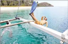  ?? JES AZNAR/THE NEW YORK TIMES ?? A shipmate dives into the waters off the coast of Palawan province in the Philippine­s, on February 6, 2012.