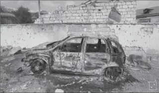  ?? MARTAKERT
-REUTERS ?? A burnt car is seen outside a hospital, which, according to the Ministry of Foreign Affairs of the Nagorno-Karabakh region, was damaged during recent shelling by Azeri armed forces, in the fighting over the breakaway region of Nagorno-Karabakh.