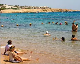  ??  ?? Sun spot: Tourists at the Egyptian resort of Sharm El Sheikh