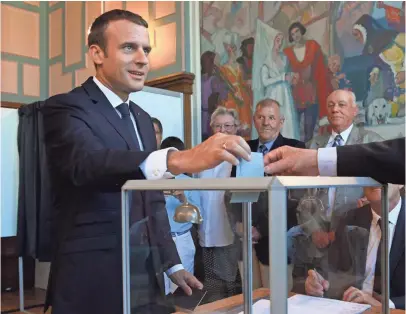  ?? POOL PHOTO BY CHRISTOPHE ARCHAMBAUL­T ?? President Emmanuel Macron casts his ballot in Le Touquet in the second round of parliament­ary elections Sunday. The political newcomer, 39, was swept into office in May, promising to lead a revolution in government.