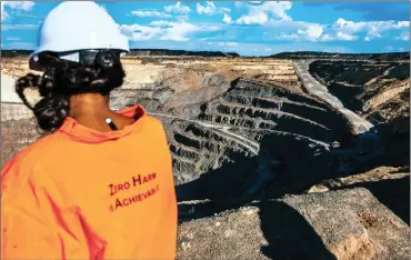  ?? PHOTO: BLOOMBERG ?? An employee looks across the open pit of the Voorspoed diamond mine, operated by De Beers in Kroonstad.