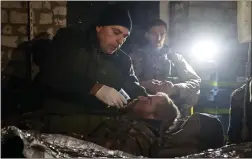  ?? ?? Ukrainian servicemen give first aid in their shelter to a soldier wounded in a battle with the Russian troops in the Donetsk region. A top adviser to Ukraine’s president has cited military chiefs as saying 10,000 to 13,000 Ukrainian soldiers have been killed in the country’s nine-month struggle against Russia’s invasion