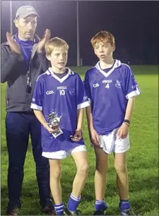  ??  ?? Rian O’Gorman and Corey O’Brien accepting the cup.