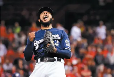  ?? AP PHOTO ?? Milwaukee Brewers relief pitcher Jeremy Jeffress celebrates after striking out Tyler O’Neill of the St. Louis Cardinals to end a Wednesday game in St. Louis. The Brewers won 2-1 to clinch a postseason spot.