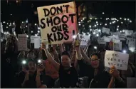  ?? CARL COURT/GETTY IMAGES ?? People hold up posters during a “mums protest” against alleged police brutality and the proposed extraditio­n treaty, near the Legislativ­e Council building on Friday in Hong Kong.