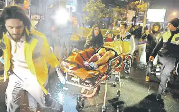  ??  ?? An injured woman being carried to an ambulance from the Reina nightclub. — Reuters photo