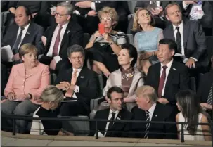  ?? The Associated Press ?? G-20: Leaders, including German Chancellor Angela Merkel, left, and their partners attend a concert at the Elbphilhar­monie concert hall on the first day of the G-20 summit Friday in Hamburg, northern Germany,.