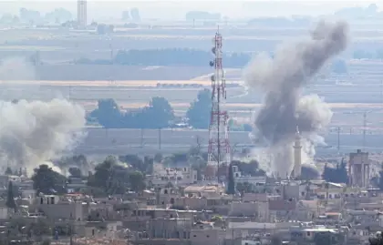  ??  ?? In this photo taken from the Turkish side of the border between Turkey and Syria, in Ceylanpina­r, Sanliurfa province, smoke billows from targets in Ras al-Ayn, Syria, caused by bombardmen­t by Turkish forces yesterday.