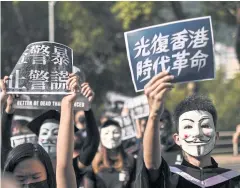  ?? AFP ?? Students wear Guy Fawkes masks, popularise­d by the ‘V For Vendetta’ film, at their graduation ceremony at the Chinese University of Hong Kong yesterday.