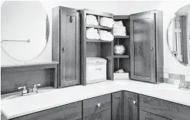  ?? Creators Syndicate photo ?? Examine this corner custom medicine cabinet and towel storage combinatio­n. Most medicine cabinets are between 4 and 7 inches or so in depth. This specific design features relatively short cabinets, but you could build this same unit taller to store...