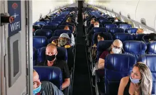  ??  ?? Masked passengers fill a Southwest Airlines flight from Burbank, Calif., to Las Vegas on
June 3. Carriers have started banning passengers who refuse to wear a face covering.