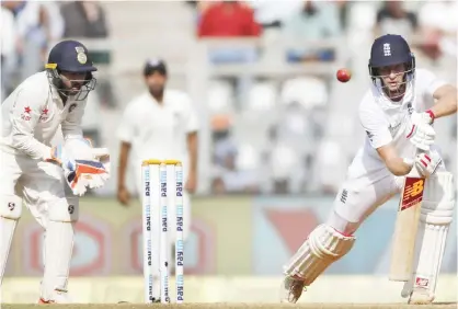  ?? —AP ?? MUMBAI: England’s batsman Joe Root, right, bats on the fourth day of the fourth cricket test match between India and England in Mumbai, India, yesterday.