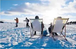  ?? JUSSI NUKARI/LEHTIKUVA ?? People sit in the sun last month in Helsinki, Finland. For the fourth consecutiv­e year, Finland topped the list of all countries in the World Happiness Report.