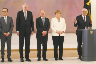  ?? Wolfgang Kumm / Associated Press ?? Chancellor Angela Merkel (second from right) is the European Union’s longest-serving leader. She was sworn in Wednesday at the head of a “grand coalition” of Germany’s biggest parties.