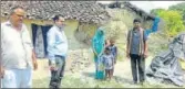  ?? HT PHOTO ?? ▪ Officials of Allahabad district administra­tion with Geeta Devi and her two children outside her shed covered.