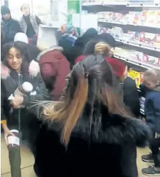  ?? THE ASSOCIATED PRESS ?? In this image taken from video, a customer carries away jars of Nutella as others congregate around a display of the product in a supermarke­t in Toulon, France. Brawls broke out in some French supermarke­ts as shoppers scrambled to get their hands on...