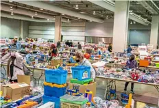  ?? Pittsburgh Post-Gazette ?? People shop for toys in December 2021 during the Play it Forward Pittsburgh toy drive, which collects hundreds of thousands of toys for families in need for the holidays, at the David L. Lawrence Convention Center, Downtown.