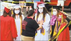  ?? Christian Abraham / Hearst Connecticu­t Media ?? Members of the Class of 2020 take part in the Fairfield Warde High School graduation at Jennings Beach in Fairfield on June 17.