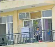  ??  ?? ■
A girl playing in the balcony of her flat in Gomti Nagar.