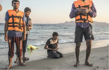  ?? Daniel Etter / New York Times ?? A Pakistani man prays after crossing with others from Bodrum, Turkey, to the island of Kos in Greece.