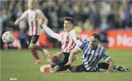  ?? ?? Sunderland’s Dennis Cirkin and Sheffield Wednesday’s Lee Gregory battle for the ball.