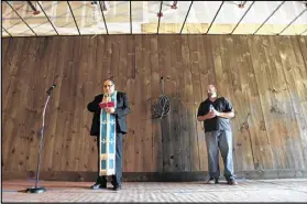  ?? BSANDERLIN@AJC.COM BRANT SANDERLIN / ?? Brian (right) had the tavern blessed by the Rev. John Azar from St. John Chrysostom Melkite Catholic Church on July 25.