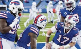  ?? ADRIAN KRAUS AP ?? Buffalo’s Josh Allen (17) celebrates with teammates, from left, Devin Singletary, Stefon Diggs and Dion Dawkins after connecting with Diggs for a second-half touchdown on Saturday.