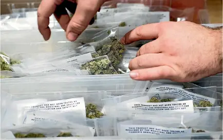  ?? PHOTO: AP ?? An employee stocks cannabis at a store shortly before the first day of recreation­al marijuana sales in San Francisco. Legalisati­on of the drug in California has resulted in a push to wipe or reduce marijuana conviction­s dating back to the 1970s.