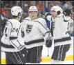  ?? ?? The Canadian Press via AP The Kings’ Phillip Danault (24), Trevor Moore (12) and Sean Durzi (50) celebrate Moore’s goal against the Oilers, Wednesday, in Edmonton, Alberta.