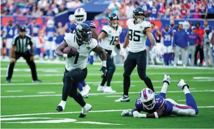  ?? ?? Travis Etienne runs in for one of his two touchdowns against Buffalo Bills. Photograph: Mark Greenwood/IPS/Shuttersto­ck