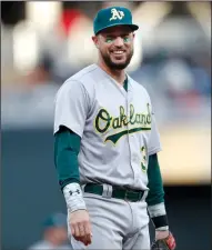  ?? JERRY HOLT/TRIBUNE NEWS SERVICE ?? The Oakland Atheltics' Trevor Plouffe smiles as he takes the field against the Minnesota Twins in Minneapoli­s on Tuesday. Plouffe spent 12 years in the Twins organizati­on.