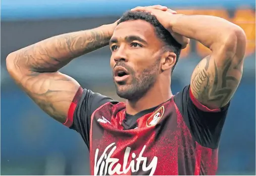  ??  ?? SLIDING TOWARDS RELEGATION: Bournemout­h striker Callum Wilson looks dejected after missing a chance to equalise at the Etihad