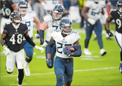  ?? NICK WASS/AP PHOTO ?? Tennessee Titans running back Derrick Henry (22) runs for a game-winning touchdown against the Baltimore Ravens during overtime of Sunday’s game in Baltimore. The Titans won 30-24.